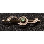 A 9ct yellow gold bar brooch set with a green stone.