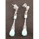 A pair of silver drop earrings set with marcasite and turquoise.