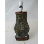 A bronze table lamp with Chinese character marks as decoration.