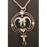 An Art Nouveau 9ct yellow gold necklace with pendant set with peridots and small pearls.