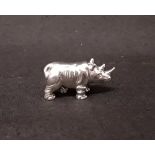 A silver figure of a rhino.