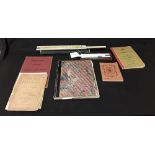 An assortment of scientific and mathematical books including one hand written, and two slide rules.