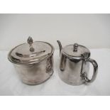 A silver plated wine cooler/ice bucket and teapot.