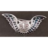 A silver and plique a jour brooch in the form of an owl.