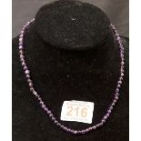 A string of purple quartz beads approximately matching in size, with a white metal clasp.