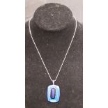 A silver necklace marked 925 with a large blue studio glass pendant.