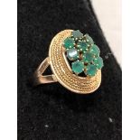 An Egyptian 14ct yellow gold ring set with 10 small emeralds