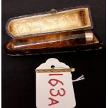 An amber cheroot holder with 9ct gold rim together with an 18ct gold brooch.