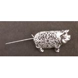 A silver brooch in the form of a pig.