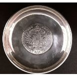 A silver pin dish marked 925 with a large silver coin to the centre.