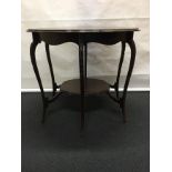 A mahogany hexagonal table with scalloped edges.