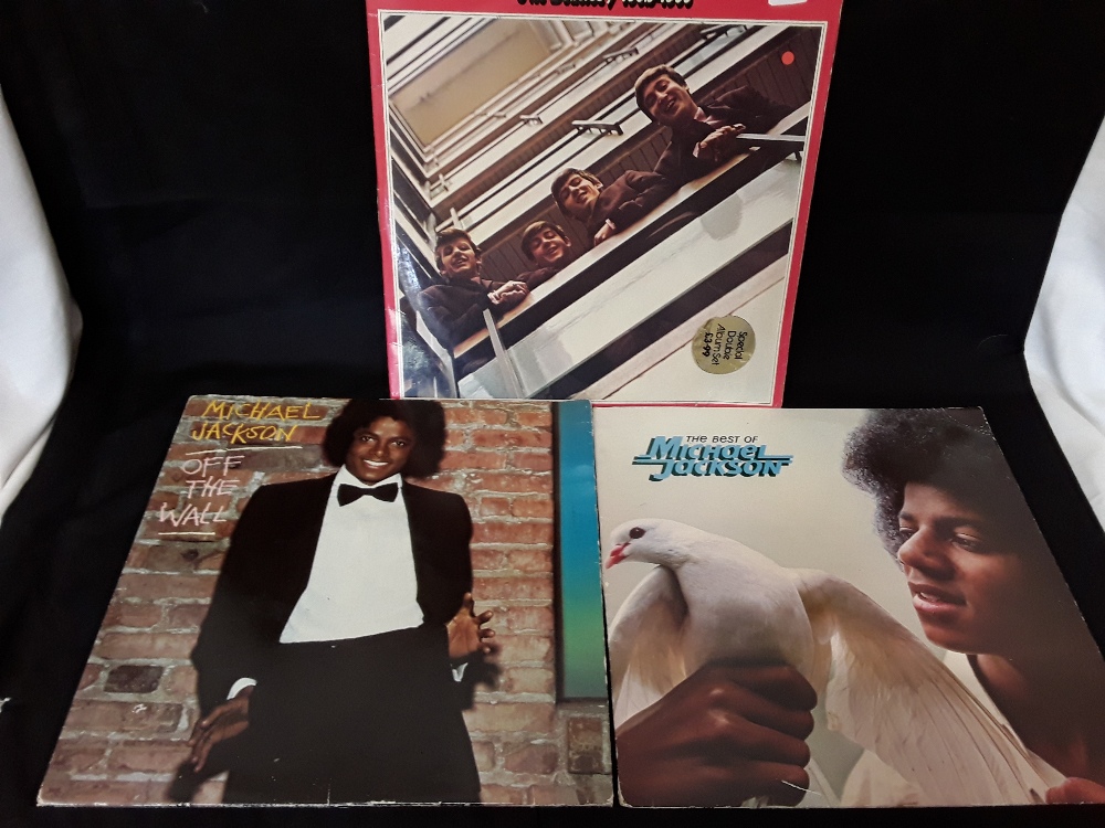 A set of three vinyl LPs comprising two by Michael Jackson and one by the Beatles.