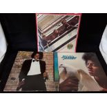 A set of three vinyl LPs comprising two by Michael Jackson and one by the Beatles.