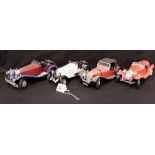 A set of four metal model cars.