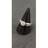 A silver and solitaire CZ dress ring.