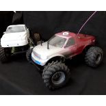 A pair of 1990's Big Foot remote control cars.