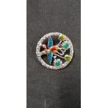 A silver and enamel brooch depicting a toucan.