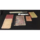 An assortment of scientific and mathematical books and slide rules.