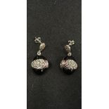 A pair of silver designer style earingsin the form of panthers set with onyx and marcasite.
