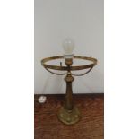 A solid brass table lamp, the base decorated with floral designs including grapes.