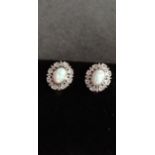 A pair of silver, CZ and opaline earrings.