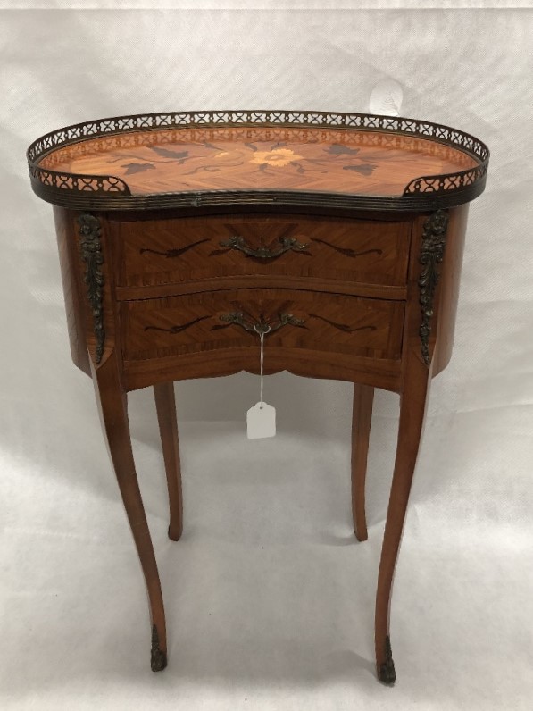 A French occasional table of small proportions with marquetry inlay.