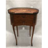 A French occasional table of small proportions with marquetry inlay.