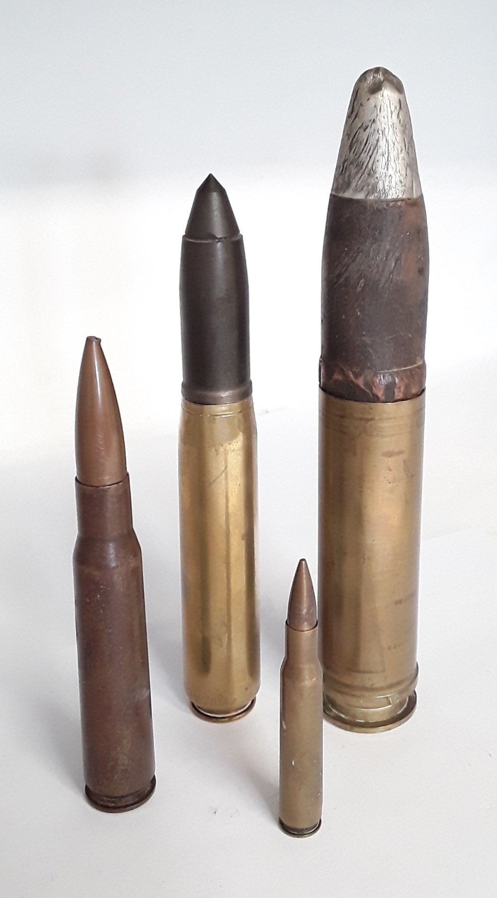 Two inert cannon rounds together with two inert bullets.