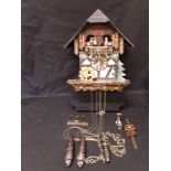 A Lotscher cuckoo clock in the form of a Swiss chalet.