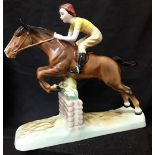 A Beswick figurine of a girl on a jumping horse (excellent condition).