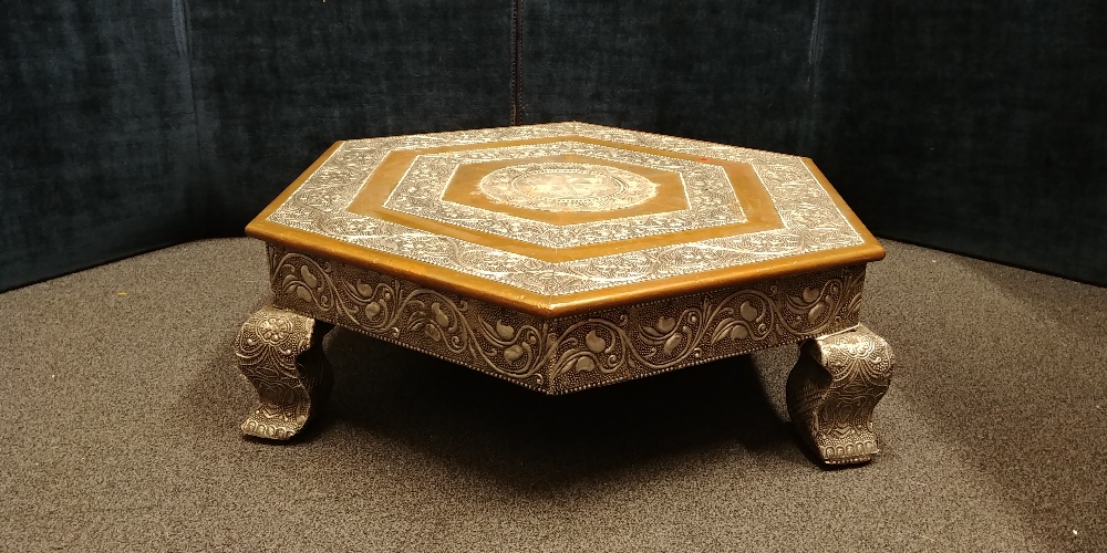 An Indian hexagonal silver wrapped and copper coffee table of small proportions.