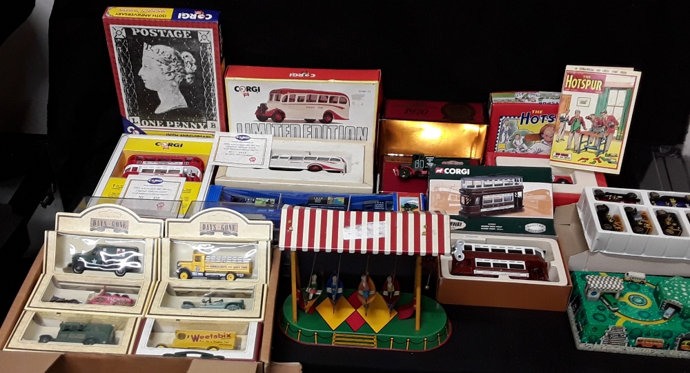 A collection of boxed vintage vehicles together with two tin toys.