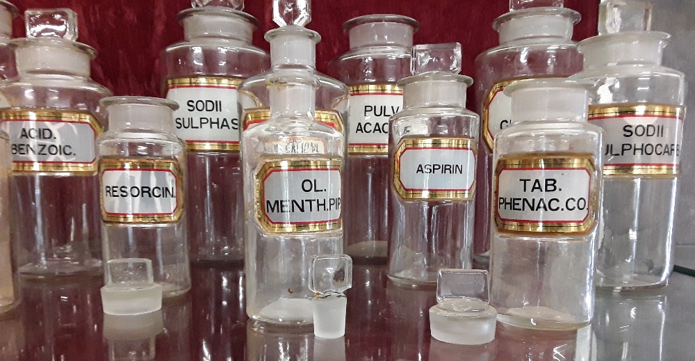 Fourteen original vintage chemist jars.