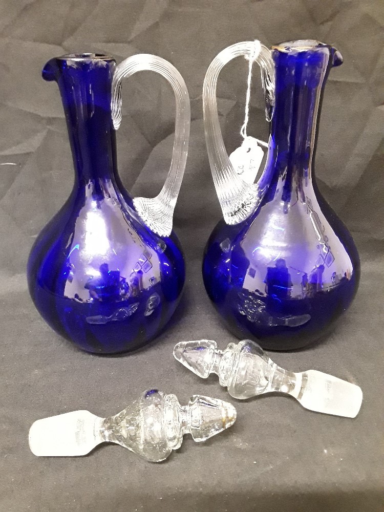 A pair of Mary Scott hand blown blue glass decanters/water jugs decorated with white enamel figures. - Image 2 of 6