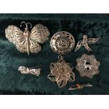 Collection of six silver and white metal brooches and a silver filigree pendant.