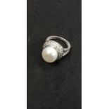 A silver ,CZ and pearl set ring..