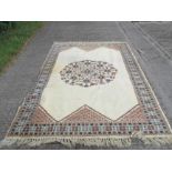 A large hand made rug in a Persian style. With cream ground.
