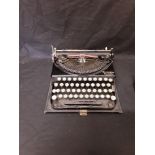 A Remington portable typewriter in original case.
