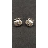 A pair of silver owl shaped cufflinks.