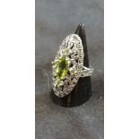 A silver, marcasite and peridot dress ring in the Art Deco style.