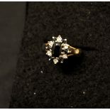 A 9ct yellow gold, diamond and black sapphire ring.
