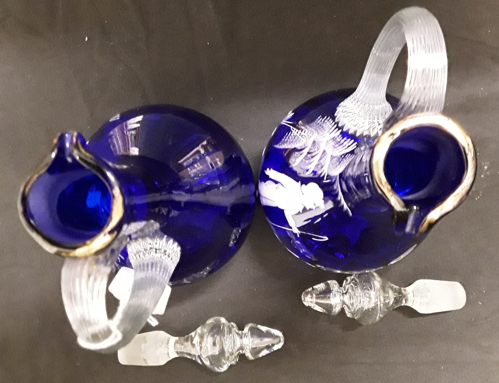 A pair of Mary Scott hand blown blue glass decanters/water jugs decorated with white enamel figures. - Image 3 of 6