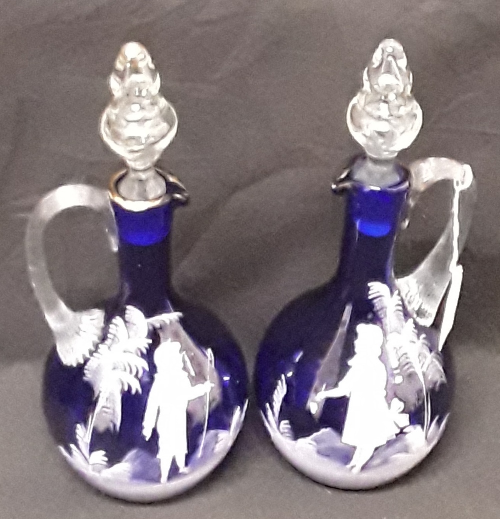 A pair of Mary Scott hand blown blue glass decanters/water jugs decorated with white enamel figures. - Image 4 of 6