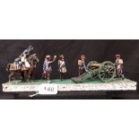A miniature diorama depicting 18th/19th Century soldiers, including a drummer, cannon, cavalry, etc.