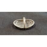 A silver miniature woven style basket