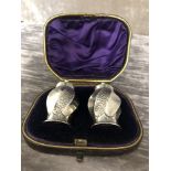 A pair of silver salt and pepper shakers. Hallmarked Birmingham 1981, maker's mark S.L. In original