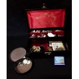 A jewellery box containing vintage jewellery including some silver.