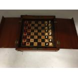 A ivory miniature travelling chess set in folding wooden box.