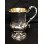 A silver tankard with gold gilt to the insides and etched decoration.