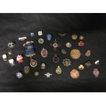 A large collection of military and enamel badges including Butlins, Bristol Motorcycle Club etc.